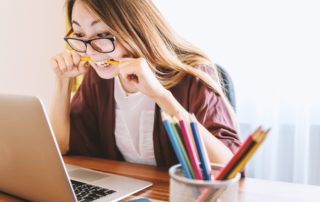 woman biting pencil