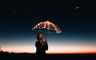 woman with lighted umbrella